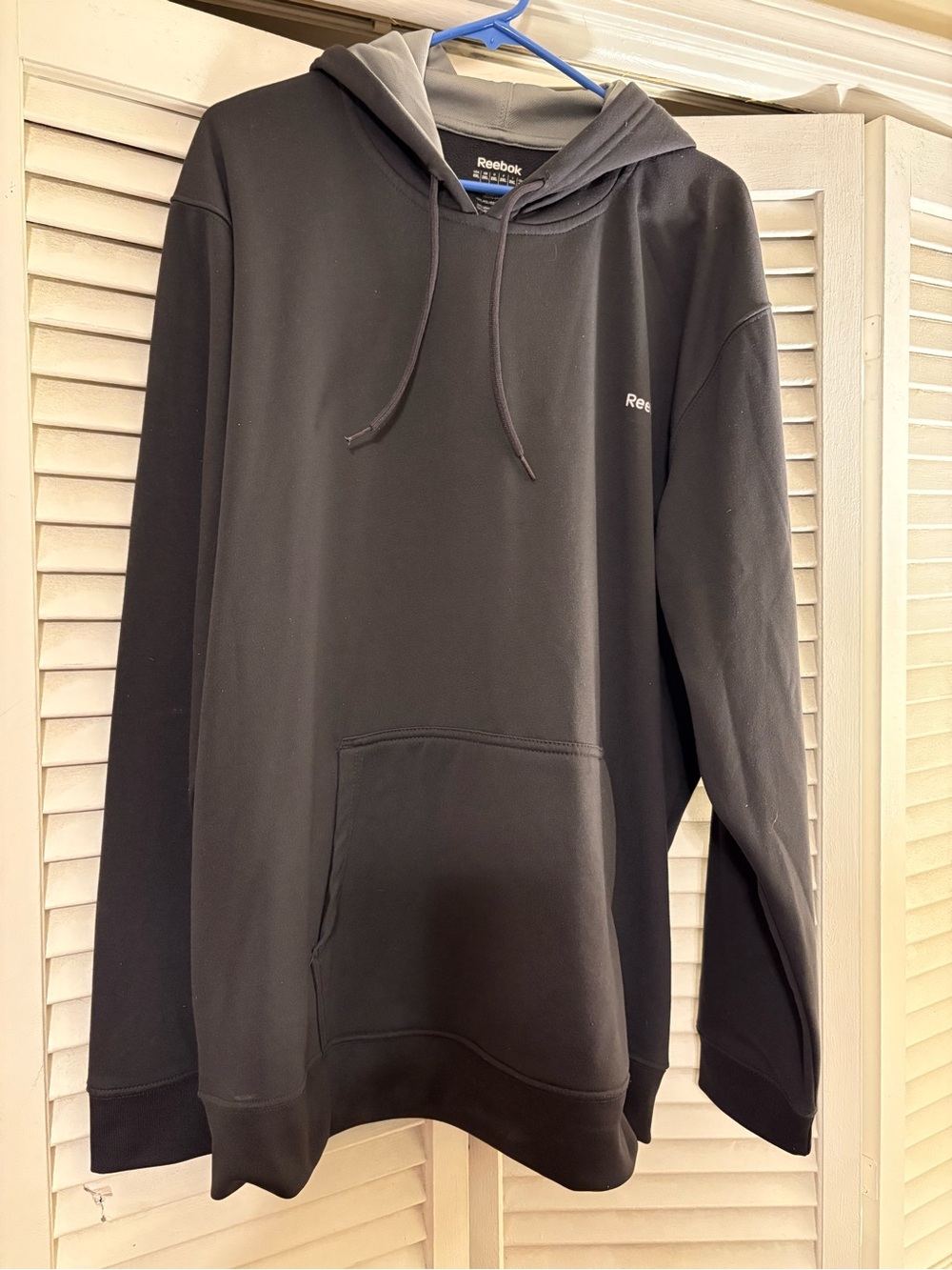 Reebok Grey Pull Over  With Pocket On The Front.